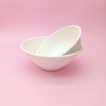 Ciotole bio, una dentro l'altra, su sfondo rosa